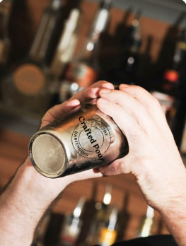 The Crafted Pour bartender working with a cocktail shaker